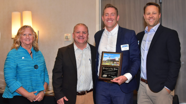 Carmen Kasner, Chapter President of APWA; Joe Lochetto, Clark Construction; Paul Jackson, Program Manager for Mission Valley in SDSU's Department of Planning, Design, and Construction, holding the Project of the Year award from the American Public Works Association San Diego/Imperial Chapter; and Mark Moss, Schmidt Design Group. (Photo: American Public Works Association.)